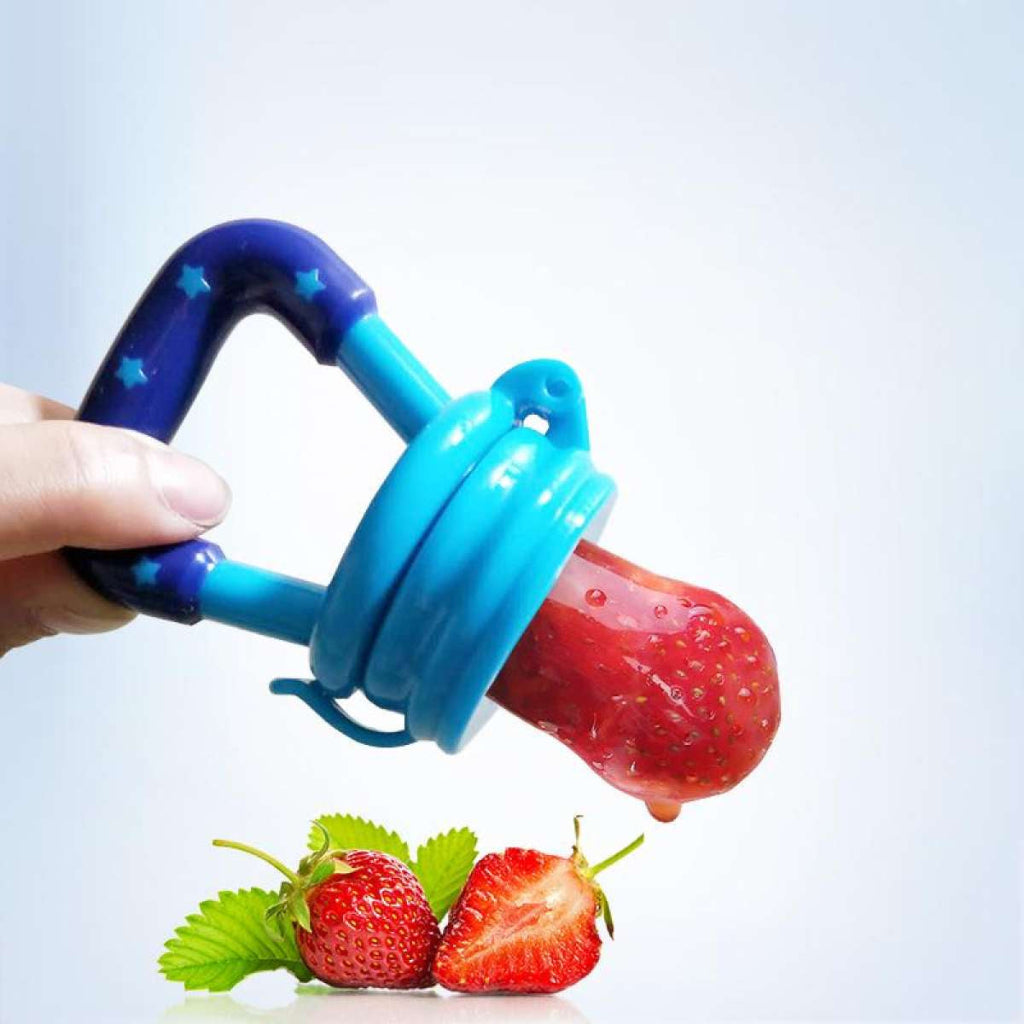 Blue fruit feeder with a strawberry, held by a hand, on a light blue background.