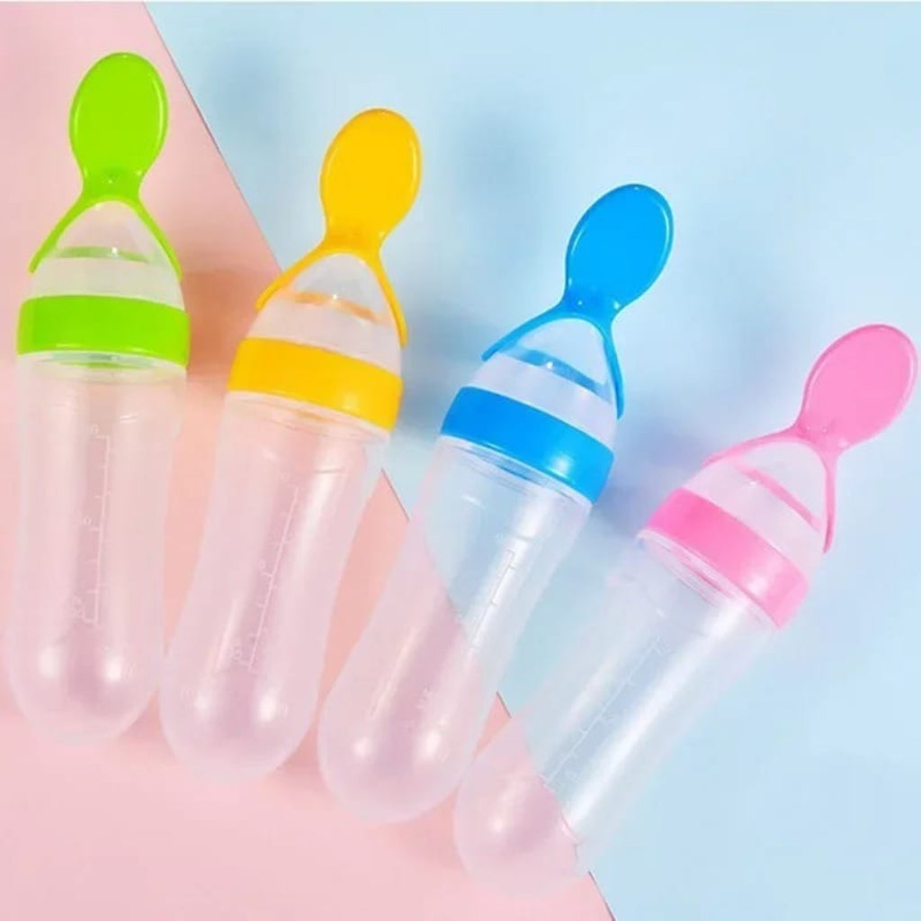 Four colorful baby feeding bottles with silicone spouts on a pastel background